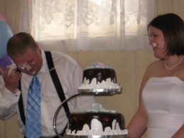 photo of wedding cake smeared on faces
